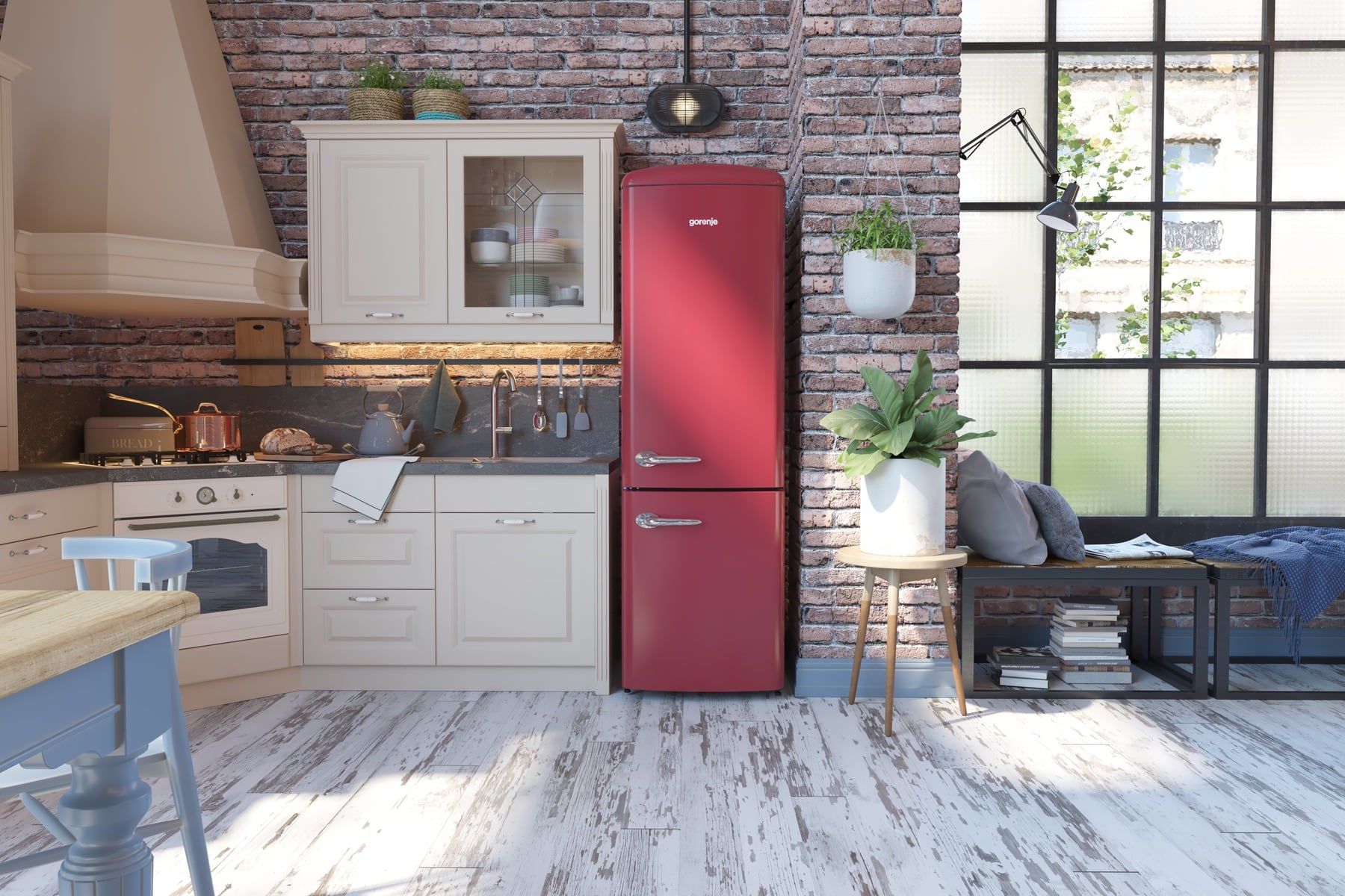 A bright red retro-style refrigerator stands out against a modern, stylish kitchen interior with brick walls.