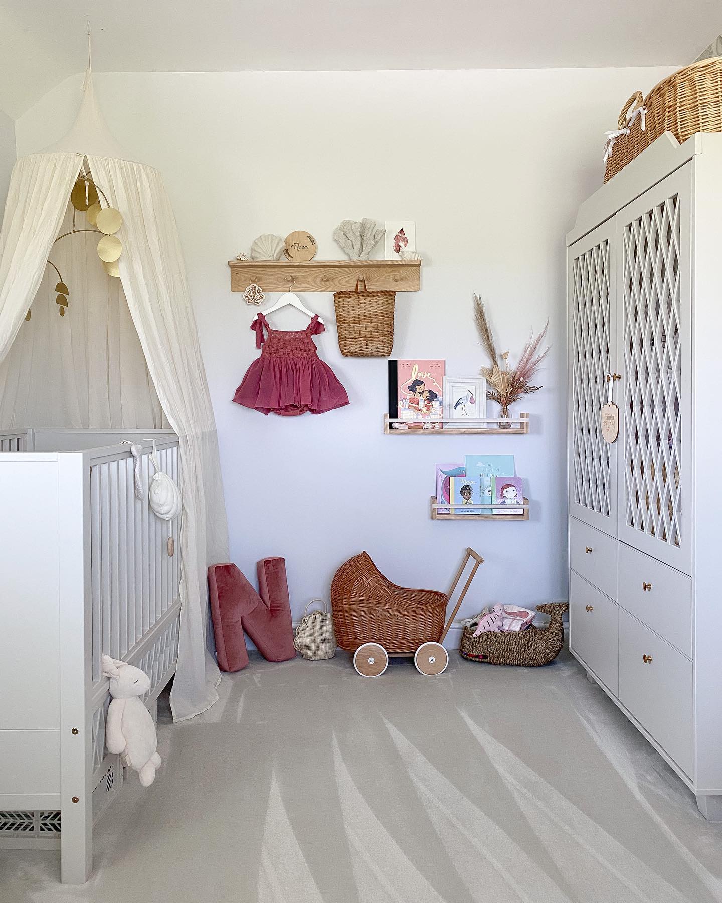 A beautifully decorated child’s room with a white crib, whimsical decorations, and soft tones creating a serene and playful atmosphere.